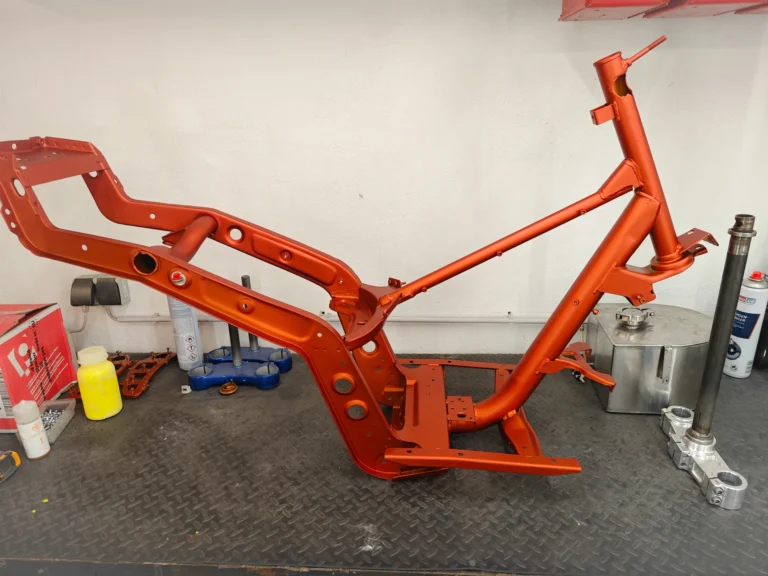Orange beschichteter Rollerrahmen auf der Werkbank